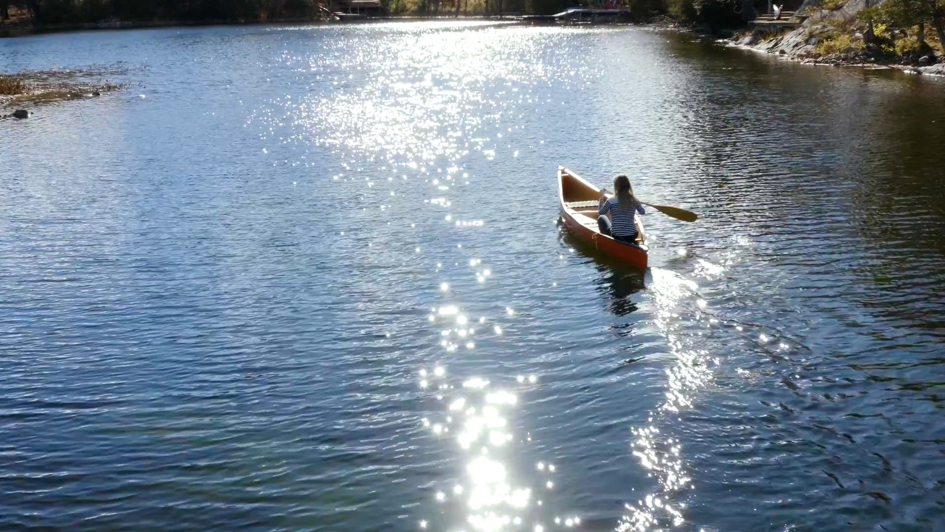 A person kayaking on a body of water