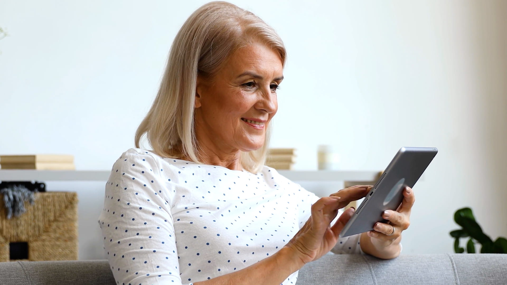 A woman interacting with a tablet