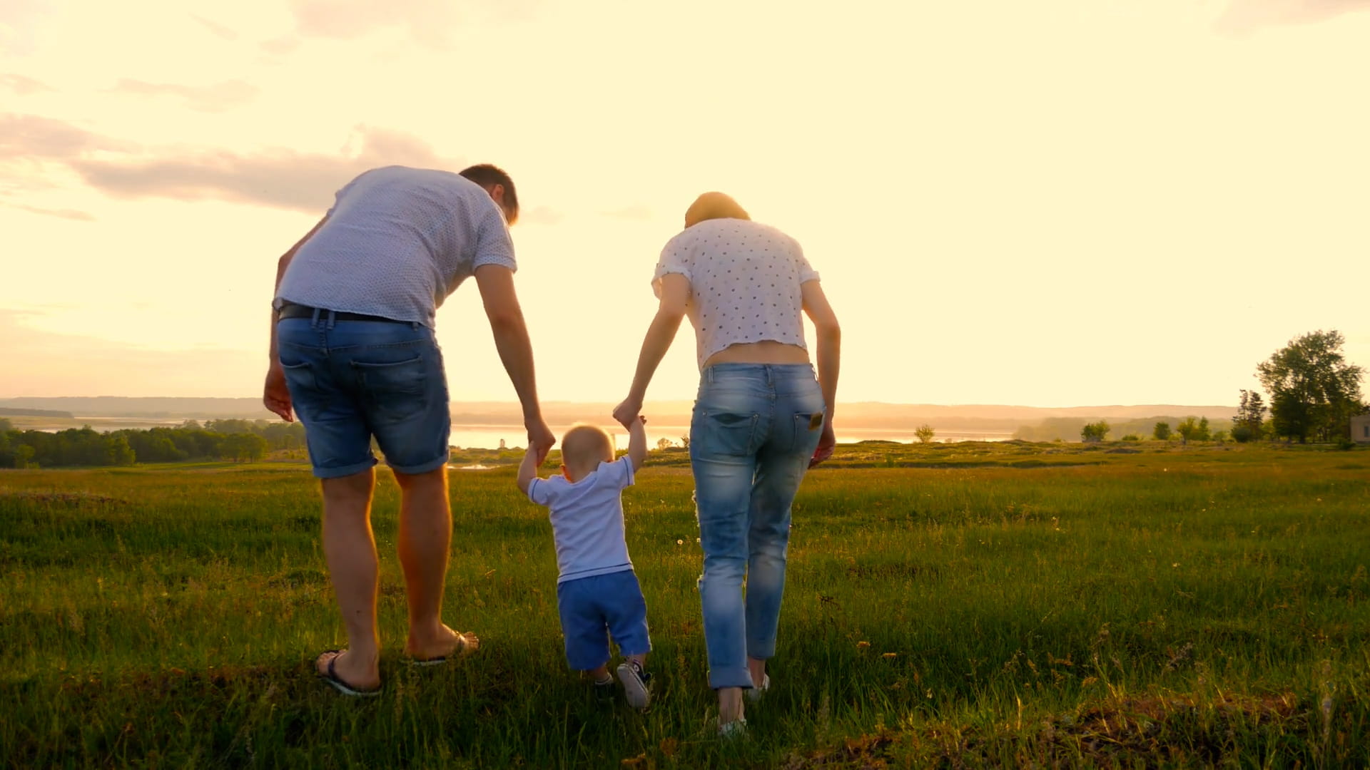 A young family walking through a field