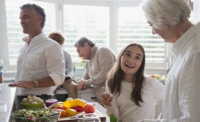 Multi-generation family cooking in kitchen